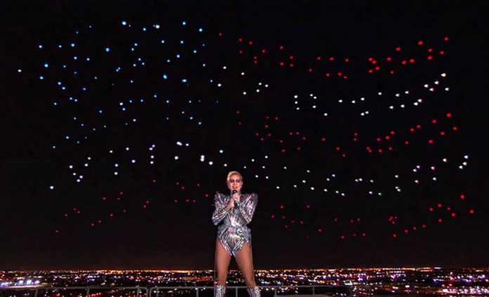 Intel drones form the United States flag behind Lady Gaga at the Super Bowl half-time show. Intel drones form the United States flag behind Lady Gaga at the Super Bowl half-time show.