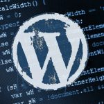 WordPress Logo on top of a sheet of code.