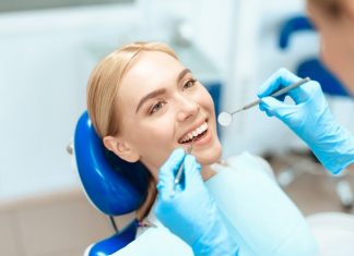 How Can A Cosmetic Dentist Beautify Your Smile? Woman Getting Dental Treatment