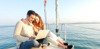 Young Couple Sailing On A Boat